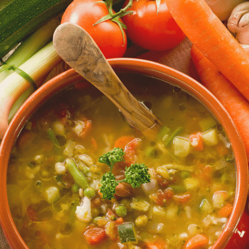 Vegetable soup with lots of fresh veggies on the side