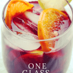 A vibrant glass of red sangria garnished with fruit