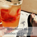 a gorgeous shot of this vibrant kombucha cocktail with bright berries and basil on ice