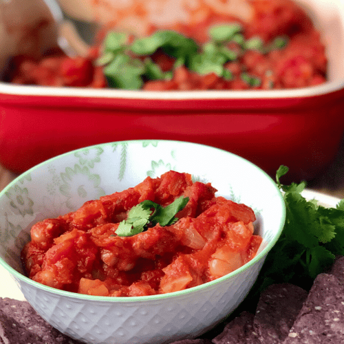 A way to serve vegan spiced baked beans with fresh cilantro and blue chips